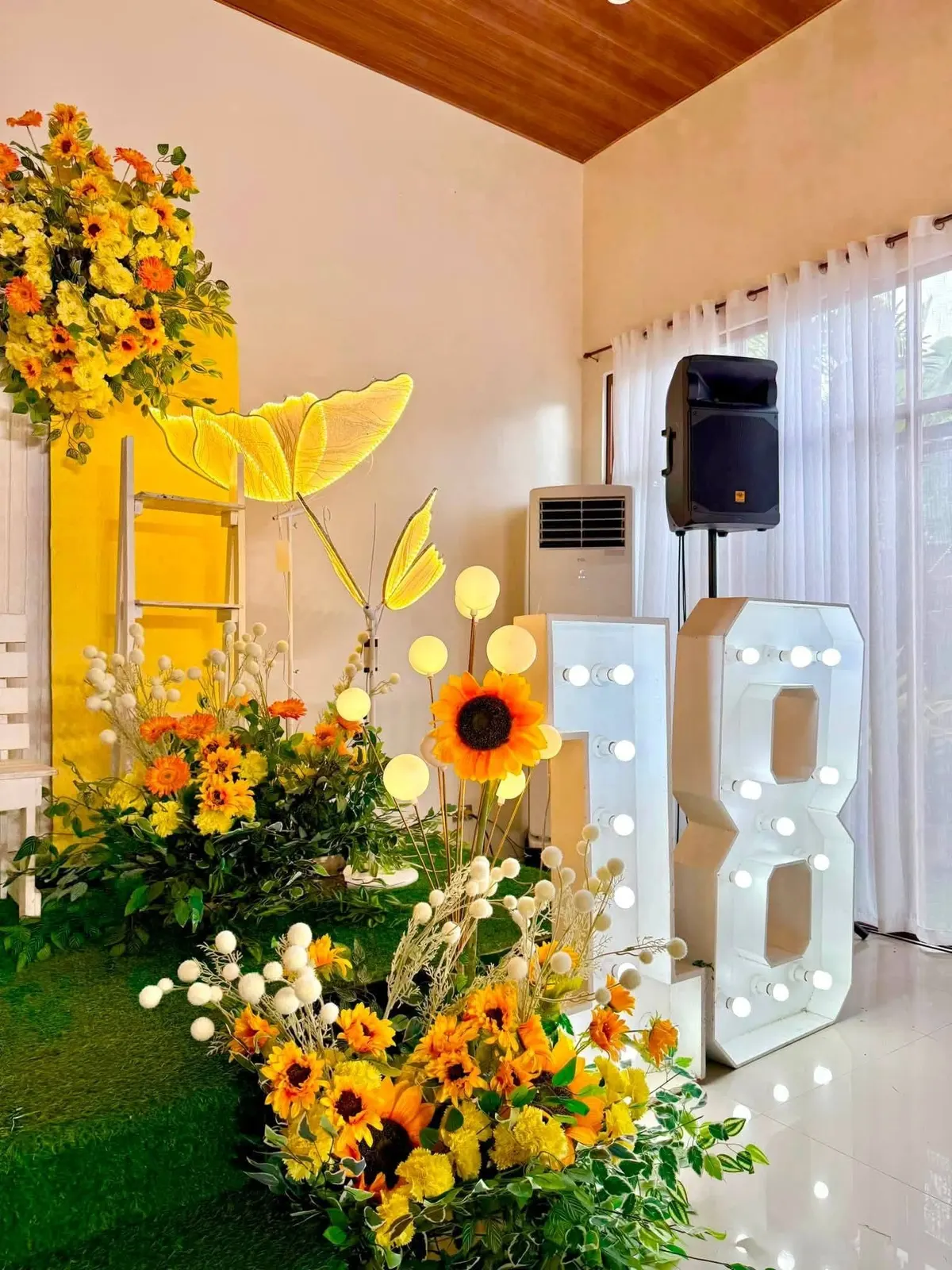 Lit 18 marquee with sunflowers