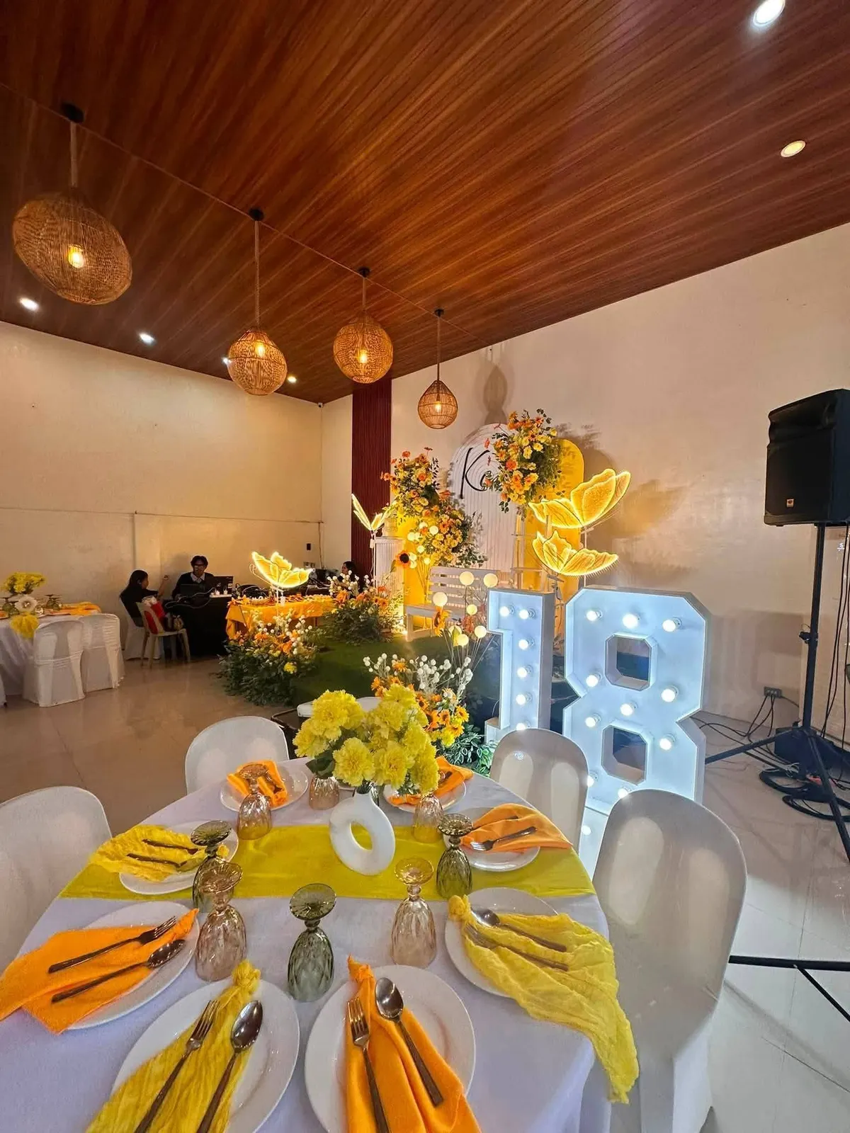 Yellow debut tables with the 18 marquee