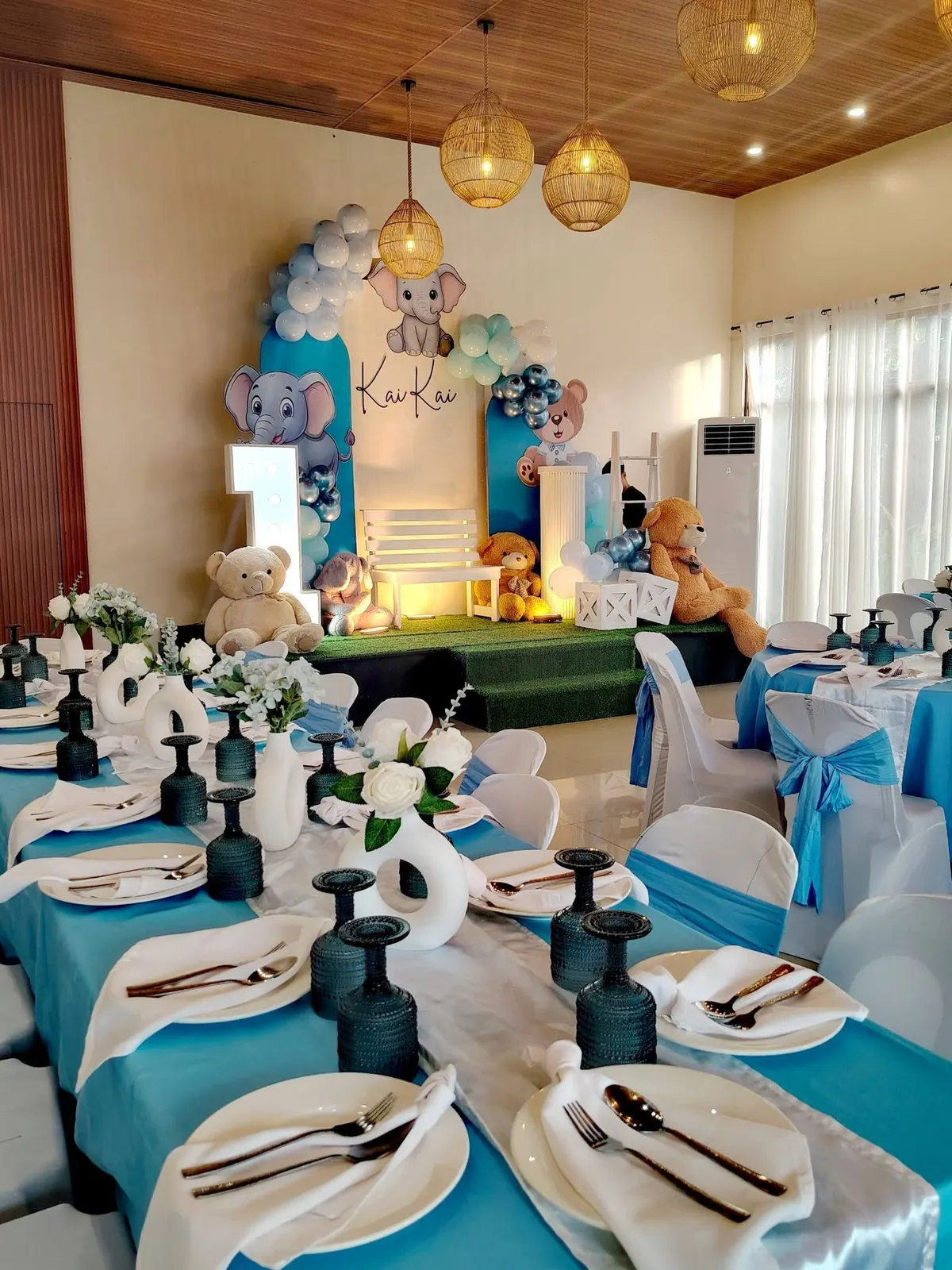 Teal and white set-up inside the hall with a floral backdrop