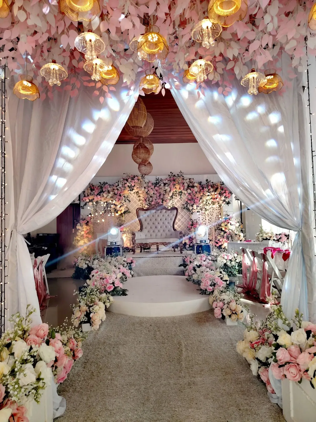 Draped wedding entrance with fairy lights